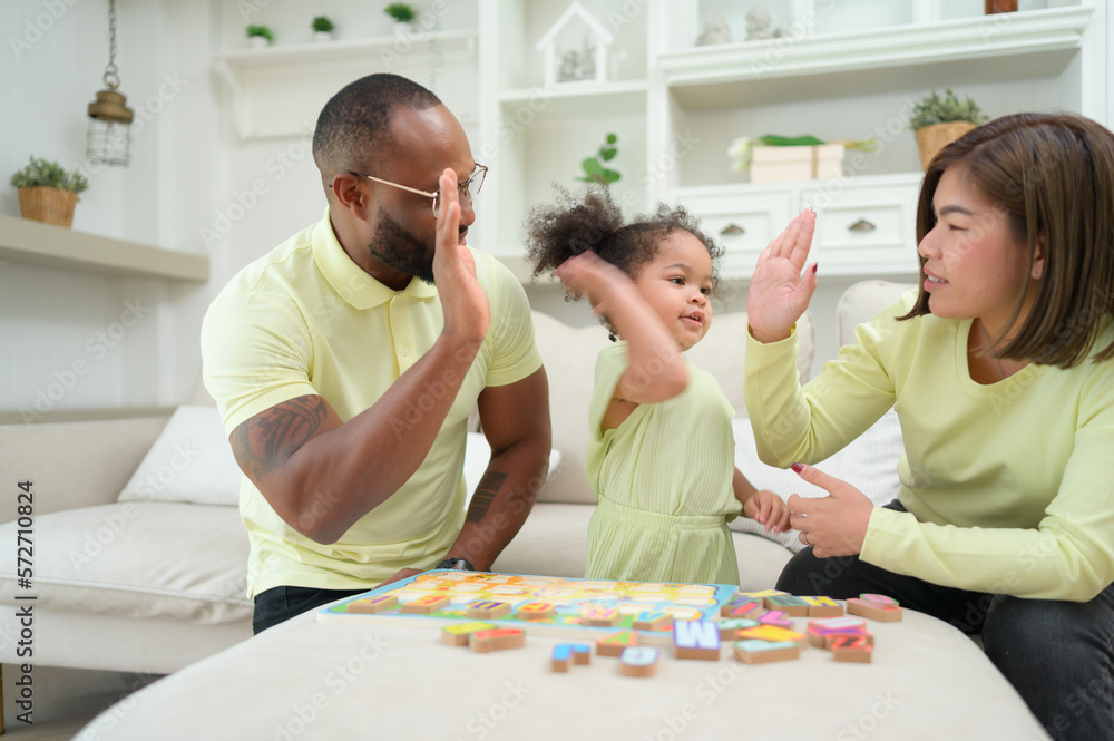 Father, Mother, and one child resting and having fun together while on vacation at home. Father, Mother, and one child resting and having fun together while on vacation at home.