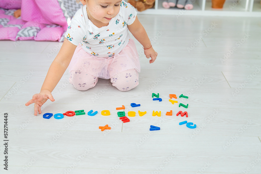 The child plays learns numbers and letters. Selective focus. The child plays learns numbers and letters. Selective focus.