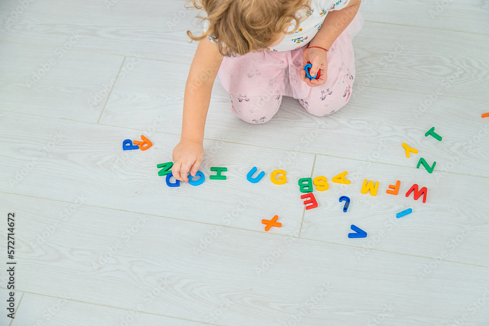The child plays learns numbers and letters. Selective focus. The child plays learns numbers and letters. Selective focus.