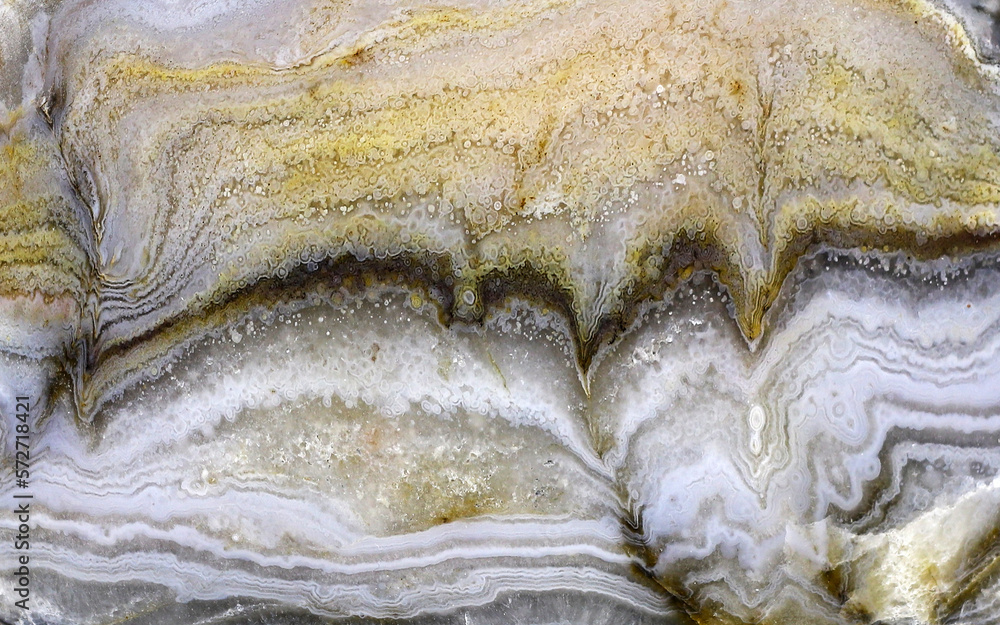 Texture of a colorful natural stone with layer structure as a background Texture of a colorful natural stone with layer structure as a background