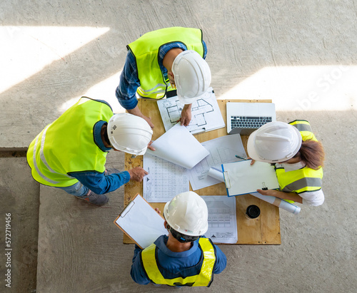 Teamwork of civil technician engineer and professional architect working together to inspect and discuss the infrastructure of building construction progress at site