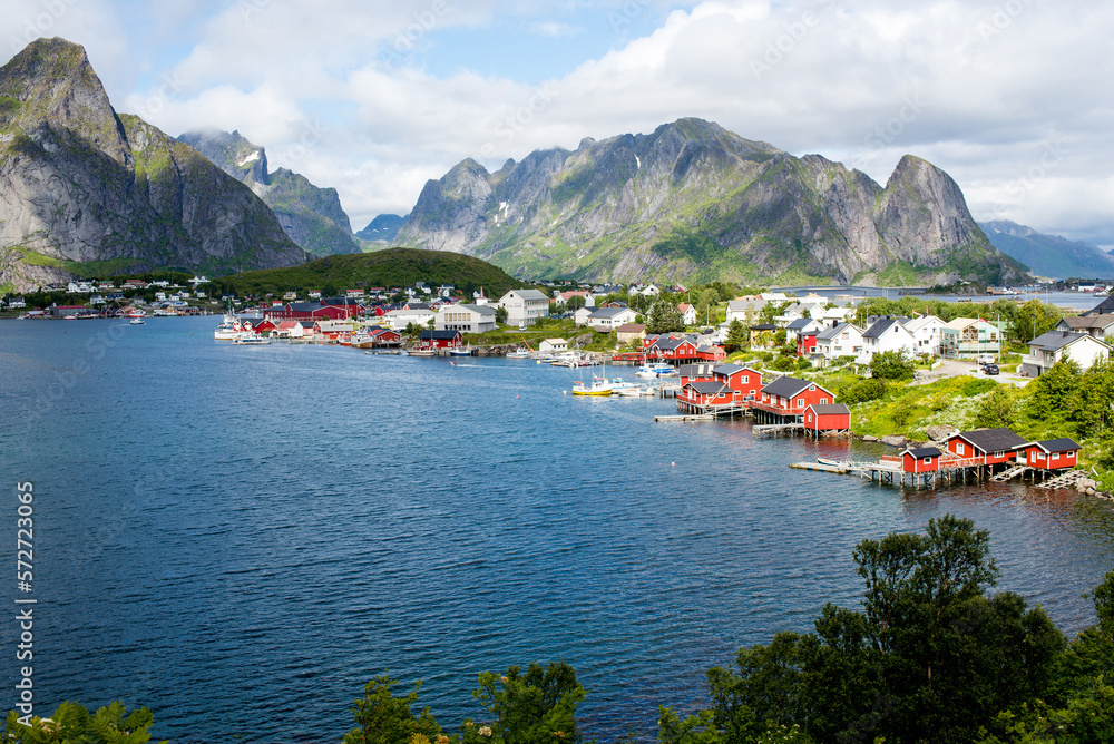 View of a fishing village from a fjord in the Lofoten Islands. Reine. Red Scandinavian houses on the shore of the fjord
