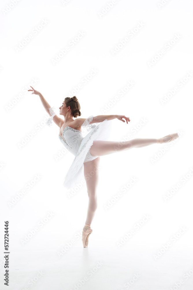One Caucasian young beautiful ballet dancer in tutu and ballet shoe isolated on white background. Sport, art concept. One Caucasian young beautiful ballet dancer in tutu and ballet shoe isolated on white background. Sport, art concept.