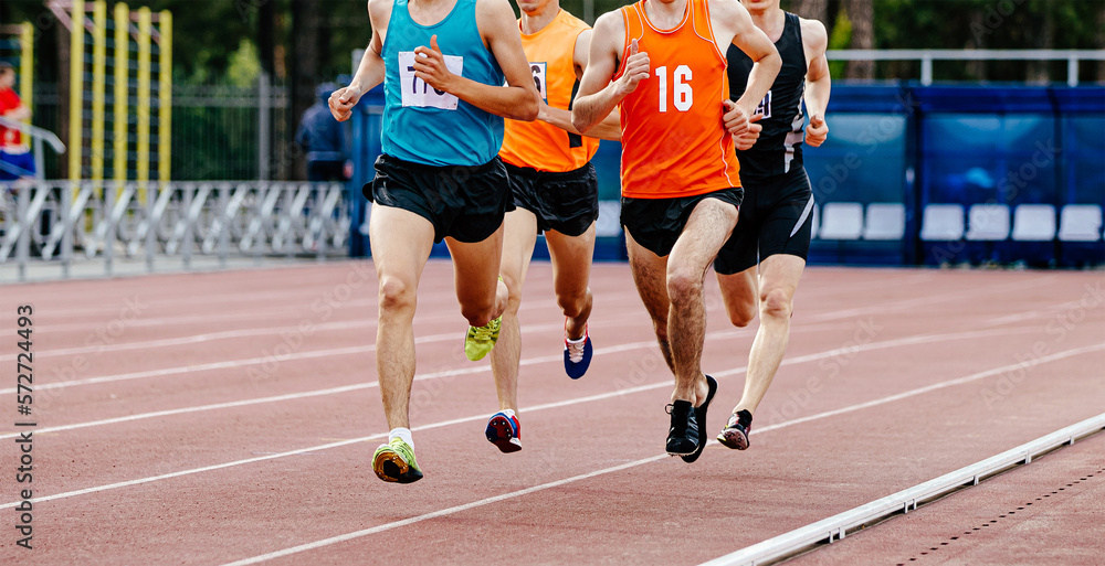 Fototapeta premium male runners run in stadium middle ditsance in athletics