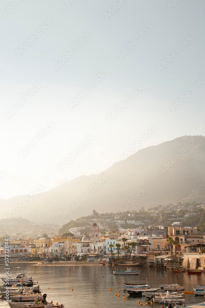 Ischia Italy harbor with palm trees and Italian wooden boats at sunrise on the Tyrannian Sea