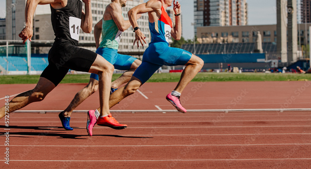 men sprinters run on track stadium in athletics competition - obrazy, fototapety, plakaty 