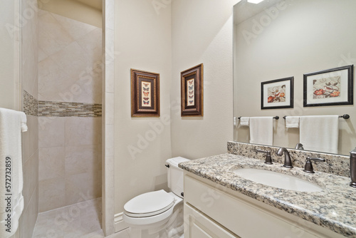 A large master bathroom with white accenting 