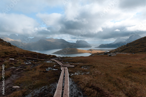 Obraz na płótnie Hiking trail Norway nature with stormy clouds and lake w salonie