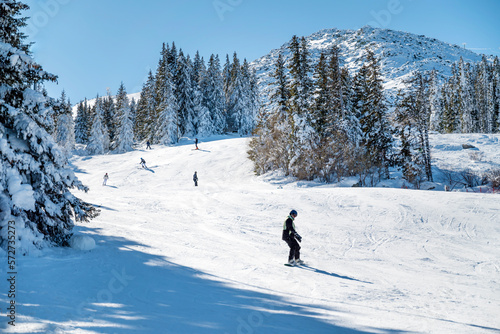 Man with snowboard on a ski slope in the beautiful winter mountain .Vitosha Mountain ,Bulgaria 