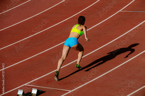 start 400 meters young woman runner run in stadium