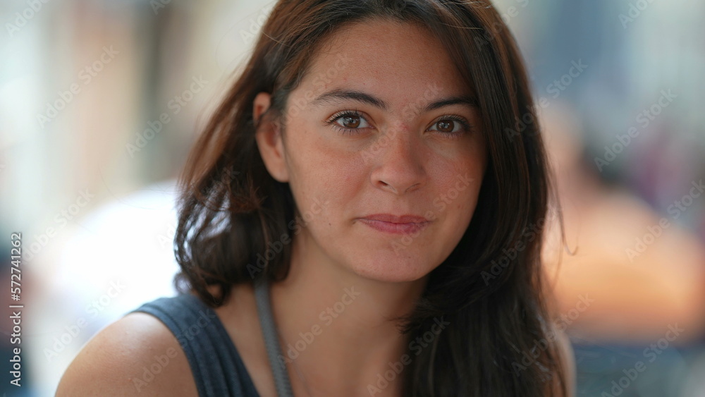 Woman closeup face portrait looking at camera. Female person in 30s