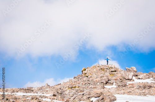 young man on top of mountain