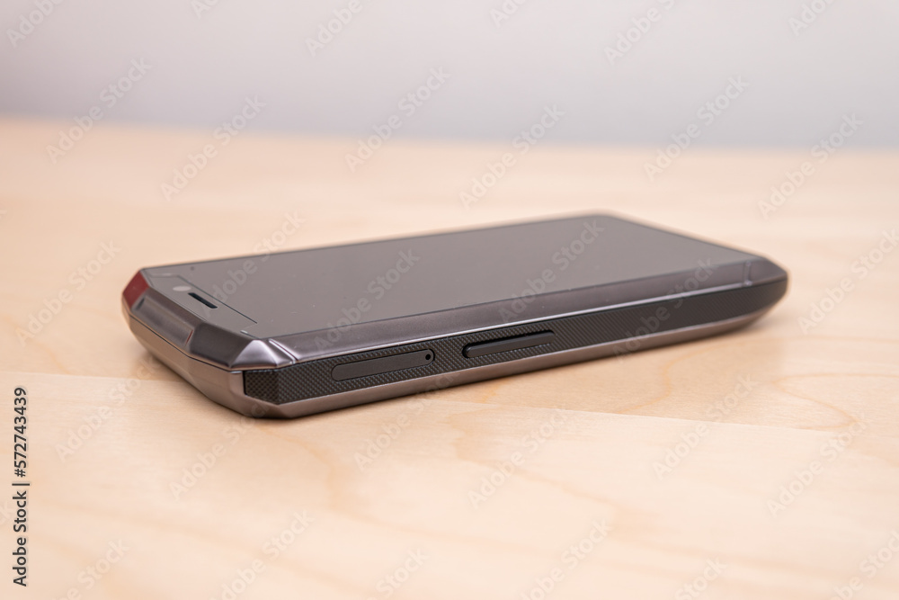 Concept of a smartphone design. Tiny smartphone on a table. Concept of a smartphone design. Tiny smartphone on a table.