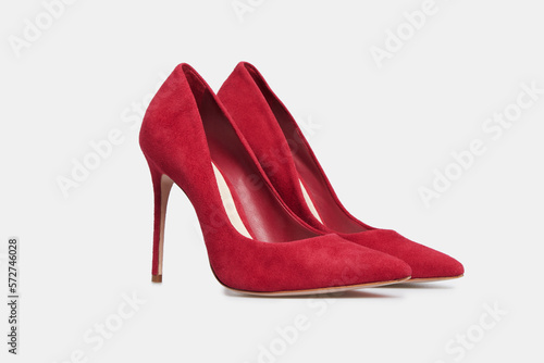 Red pointy toe women's shoes with high heels isolated on white background. Female classic stiletto heels in suede leather. Mock up, template photo