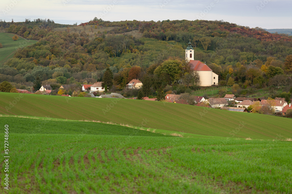 small village with church in the foreground fresh sowing