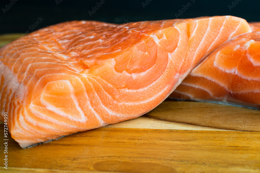 Closeup View of Two Raw Salmon Fillets: Two uncooked salmon fillets stacked on eachother Closeup View of Two Raw Salmon Fillets: Two uncooked salmon fillets stacked on eachother
