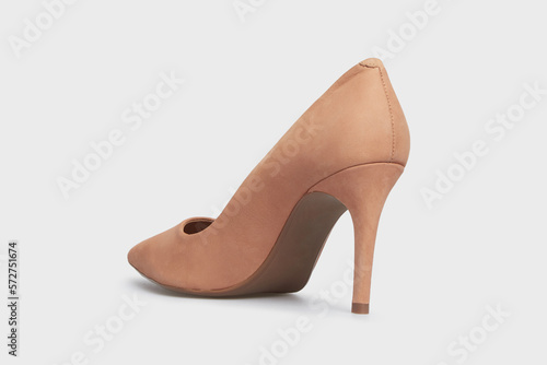 Beige nude pointy toe women's shoe with high heels isolated on white background. Female classic stiletto heels in suede leather. Behind view. Mock up, template