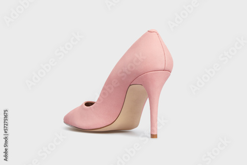 Light pink color pointy toe women's shoe with high heels isolated on white background. Female classic stiletto heels in suede leather. Behind view. Mock up, template