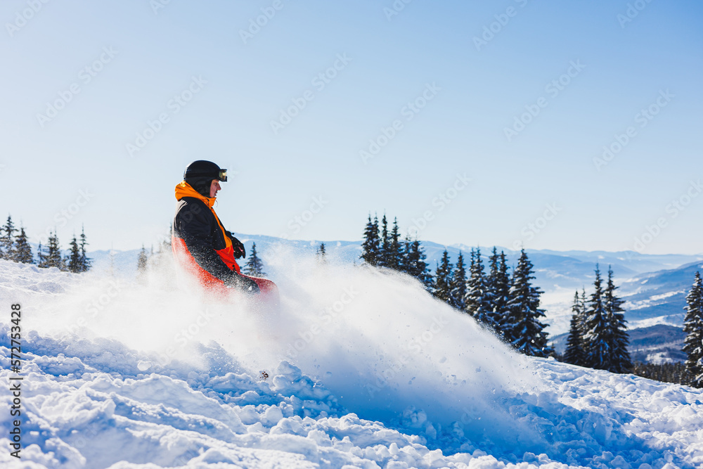A snowboarder walks down a snowy slope in winter on the snow. Snowboarding, winter freeride