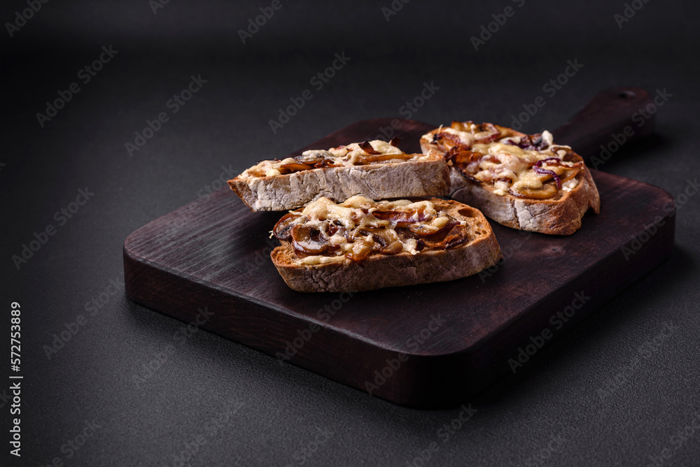 Delicious crispy toast or bruschetta with fried onion, champignon mushrooms and cheese Delicious crispy toast or bruschetta with fried onion, champignon mushrooms and cheese