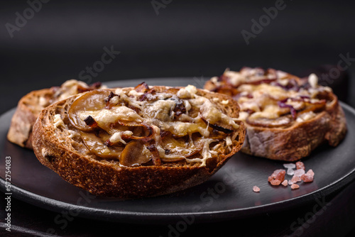 Delicious crispy toast or bruschetta with fried onion  champignon mushrooms and cheese