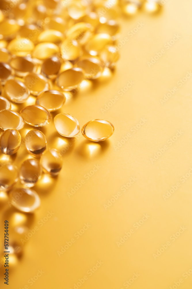 Fish oil gel capsules on yellow background in angle view. Fish oil gel capsules on yellow background in angle view.