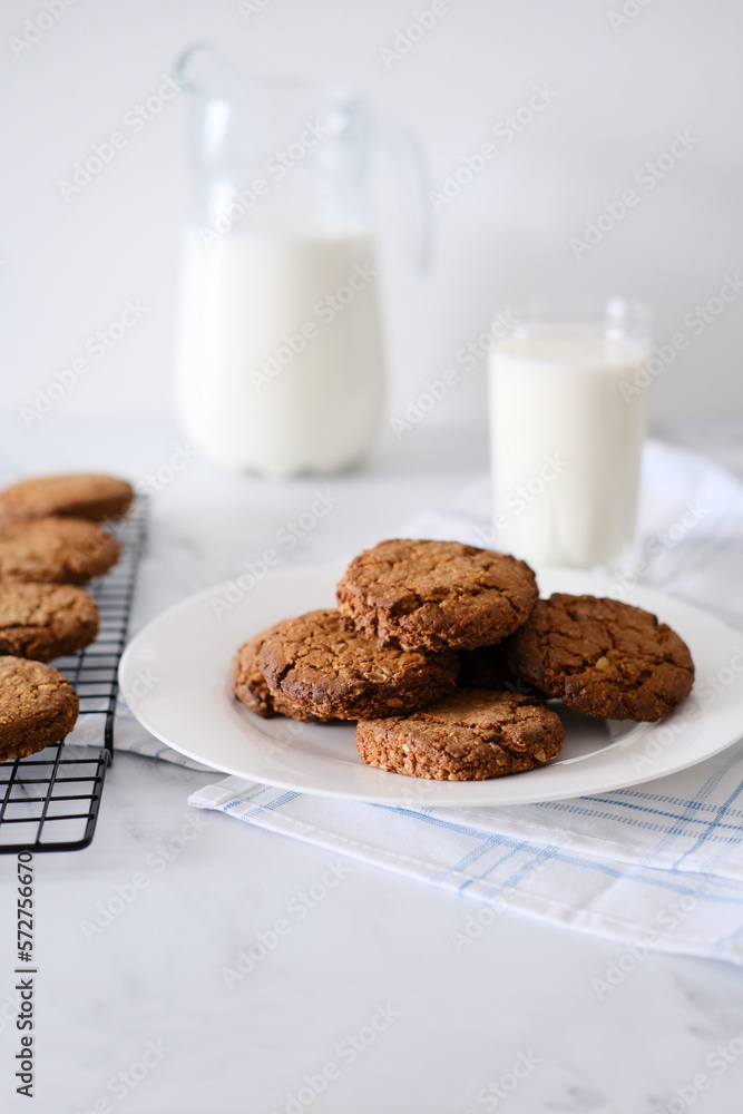 Close-up of homemade cookies on a plate against the background of milk Close-up of homemade cookies on a plate against the background of milk