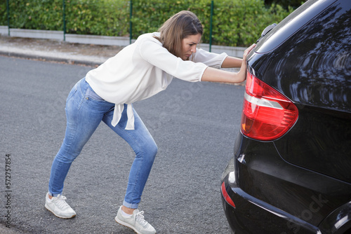 woman pushing broken down car © auremar