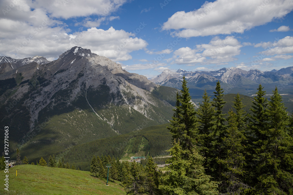 Natural landscape - Bow River Valley, Rocky Mountains, coniferous forest and beautiful sky with clouds. Summer tourism in the mountains