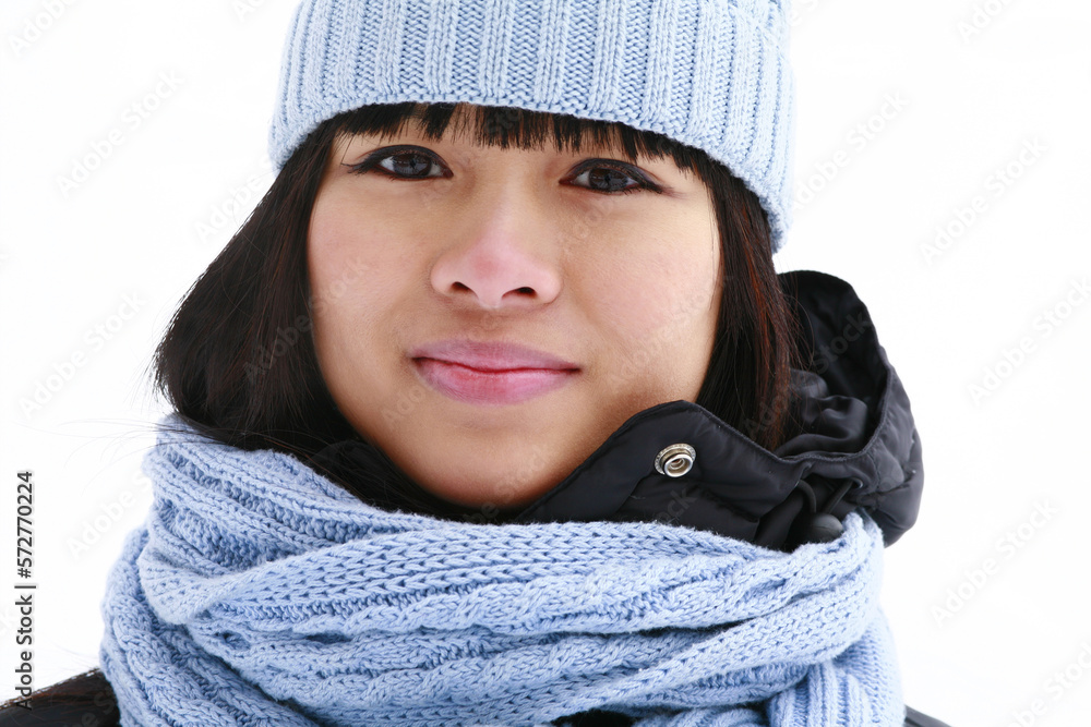 Close up portrait of young Asian woman outdoors in winter wearing wool knit tuque and scarf. Close up portrait of young Asian woman outdoors in winter wearing wool knit tuque and scarf.