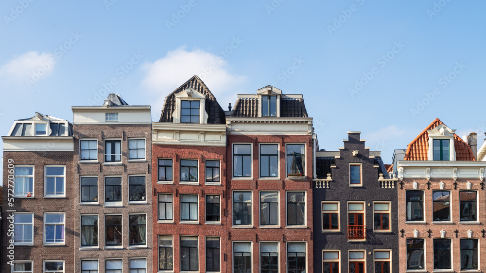 Canal houses with different facades next to each other in the center of Amsterdam.