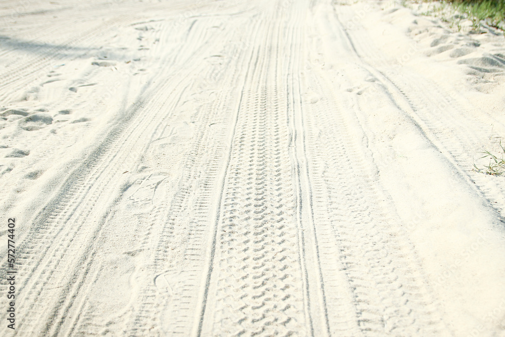 A Traces of a car in the sand near the sea in nature background A Traces of a car in the sand near the sea in nature background