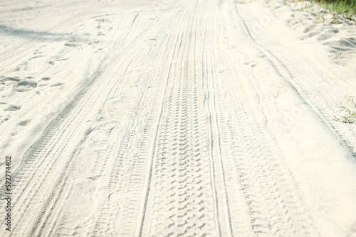A Traces of a car in the sand near the sea in nature background