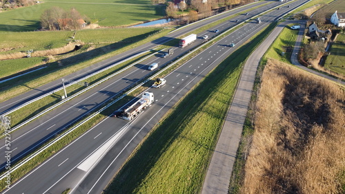 Highway seen from the air in the Netherlands captured with drone. Travel and move, connection with traffic jam and passage with progress. Safety on asphalt with entrance and exit.