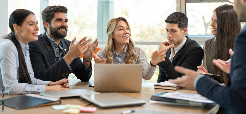 Diverse business people welcoming new employee to their team. Happy friendly business colleagues congratulating to their new coworker. Diverse business people welcoming new employee to their team. Happy friendly business colleagues congratulating to their new coworker.