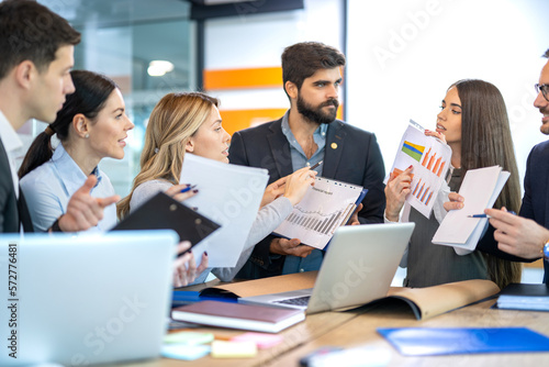 Group of business people holding documents with financial statistic reports and showing them to each other. Stock market  finance  marketing  development  economics  money and financial concept.