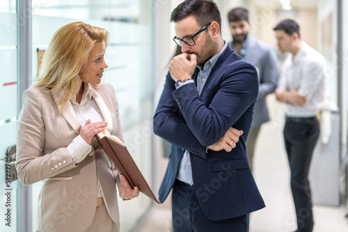 Billede på lærred Beautiful blond haired woman showing financial data and reports to her worried c