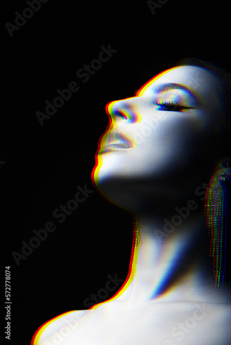 Fototapeta Naklejka Na Ścianę i Meble -  Beautiful woman studio portrait with fancy earrings blowing smoke through mouth. Model looking up with partly closed eyes. RGB channel color split effect applied. Futuristic looking style
