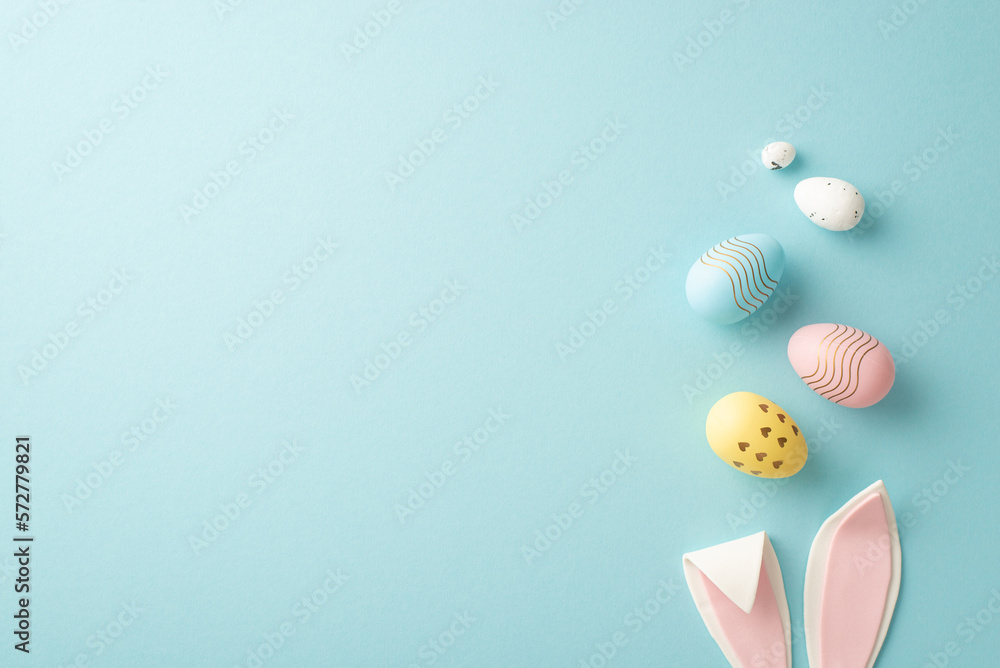 Easter concept. Top view photo of easter bunny ears and colorful eggs on isolated pastel blue background with copyspace - obrazy, fototapety, plakaty 