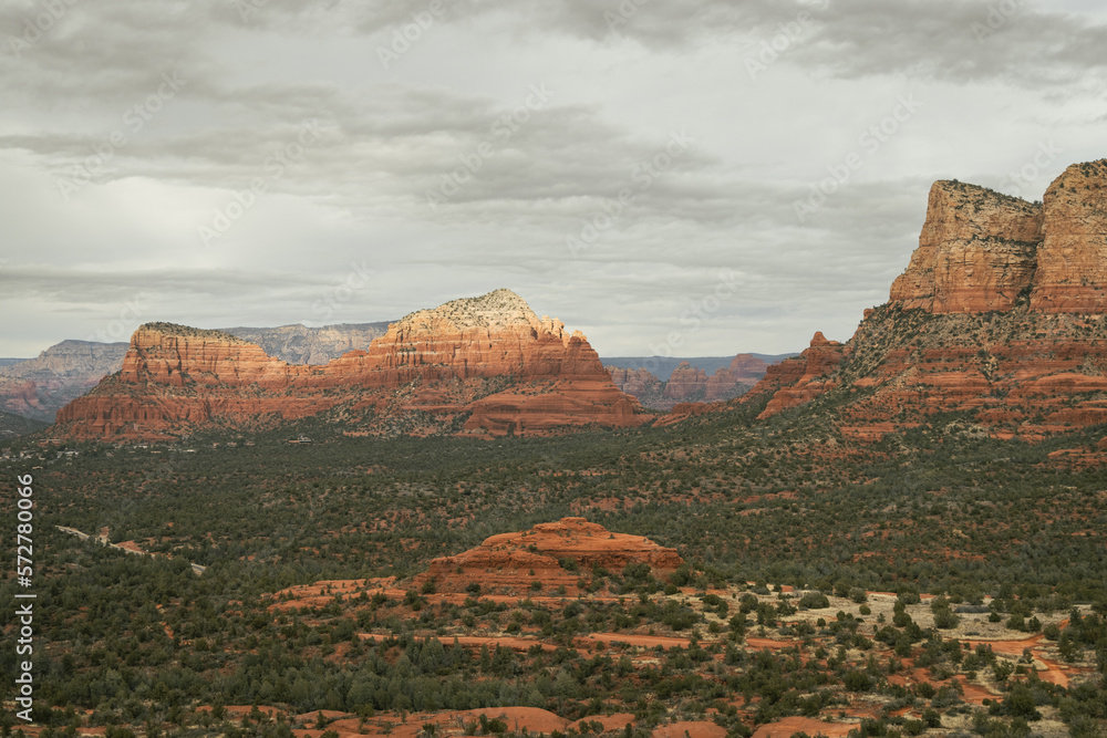Views of red rock buttes and formations within coconino national forest in Sedona Arizona USA against white cloud background. Horizontal Image.