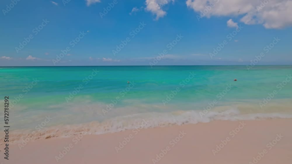 Beautiful view of sandy beach with turquoise water of Atlantic Ocean against blue sky with white clouds. Aruba. Beautiful view of sandy beach with turquoise water of Atlantic Ocean against blue sky with white clouds. Aruba.