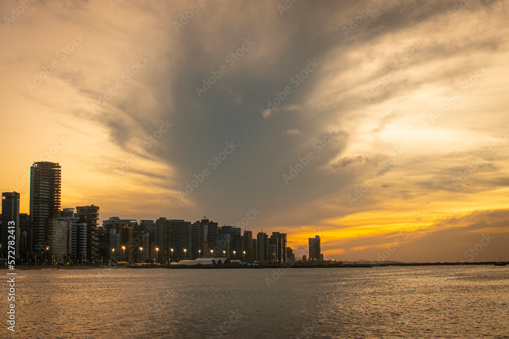 A beautiful view of a sunset, on the beach of Fortaleza-CE, Brazil, with a twilight. Exclusive and authorial photography.