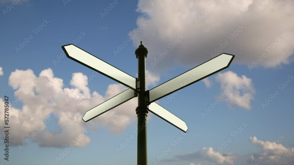 Blank directional crossroad signs over sunny blue sky Blank directional crossroad signs over sunny blue sky
