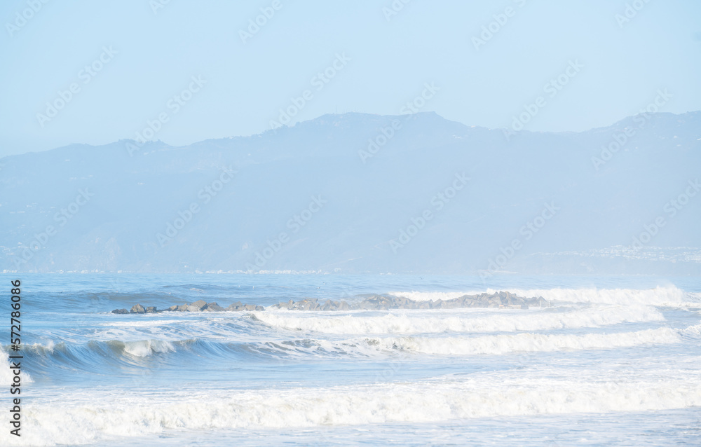 Waves crashing at the beautiful beaches in sunny Los Angeles, California. Malibu beach background