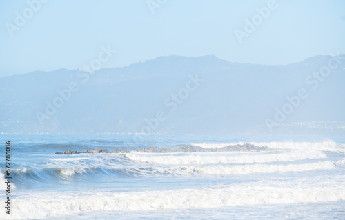 Waves crashing at the beautiful beaches in sunny Los Angeles, California. Malibu beach background