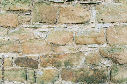 Stone wall background for graphic and leaflet use. Ancient masonry brickwork .