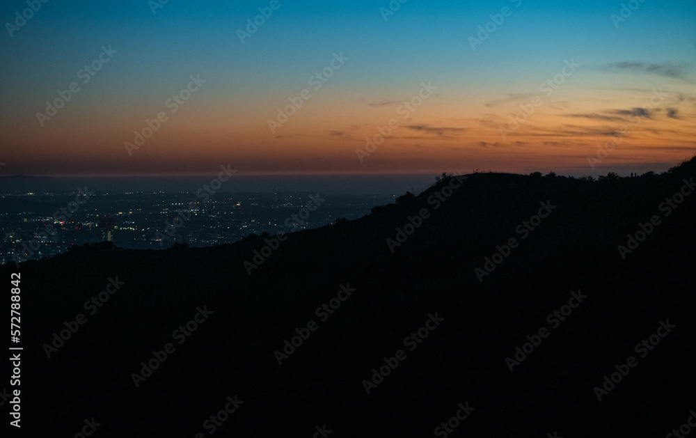 Dusk in Los Angeles, seeing all of the twinkling lights on the horizon. Post sunset background view from Runyon Canyon, California