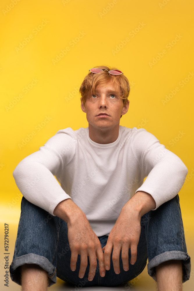 Focused redhead european teenage boy with freckles and glasses looking up Focused redhead european teenage boy with freckles and glasses looking up