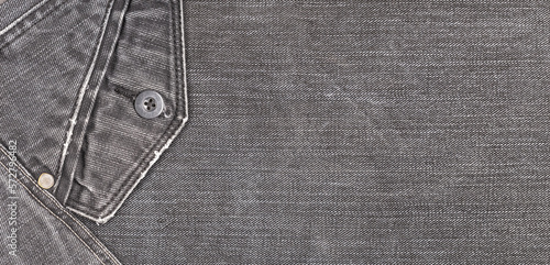 A denium gray jean closeup, banner with space for text. View of old jeans details. Denim background, texture