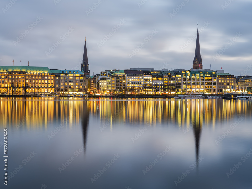 Panoramic shot of Hamburg city illuminated on lake Binnenalster on a a winter evening, Germany